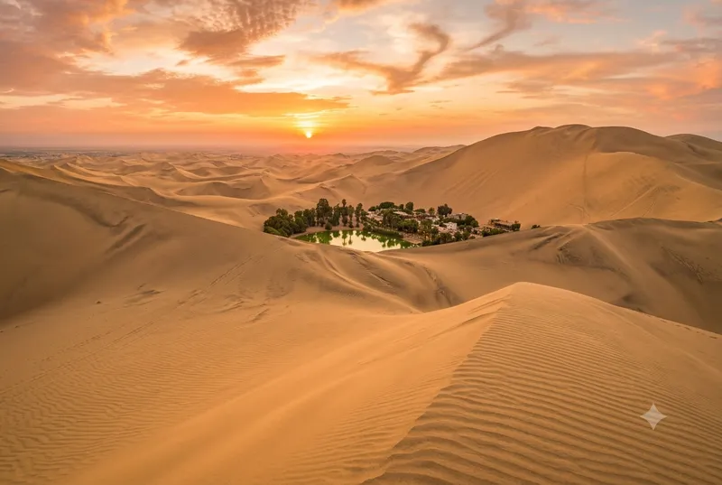 Huacachina dunes at sunset with oasis visible below — dune buggy adventure in Peru's desert