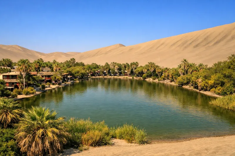 Huacachina oasis Peru — turquoise lagoon surrounded by giant sand dunes