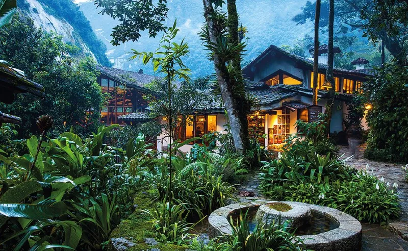 Inkaterra Machu Picchu Pueblo Hotel exterior — casitas nestled in the cloud forest with orchid gardens