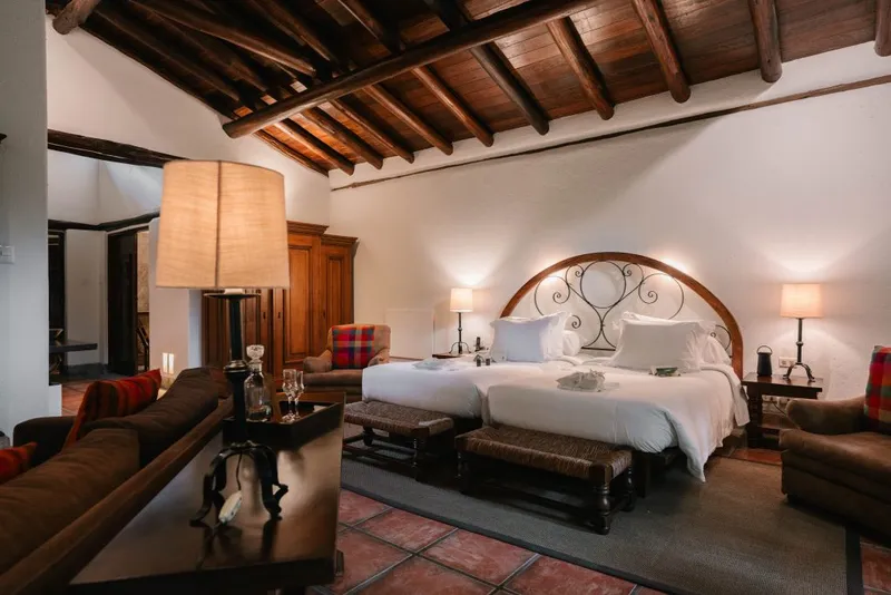 Inkaterra Machu Picchu Pueblo Hotel suite — Andean-style room with wooden beams and garden views