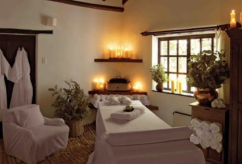 UNU Spa at Inkaterra Machu Picchu Pueblo Hotel — candlelit treatment room with natural botanicals
